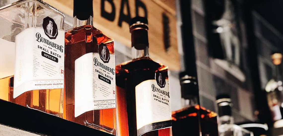 Bundaberg Rum bottles lined up on shelf