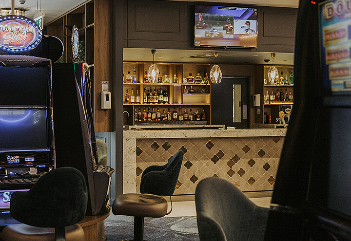 Opulence Bar in distance viewed between two pokies machines