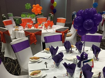 Function with different coloured balloons per table setting and matching decoration