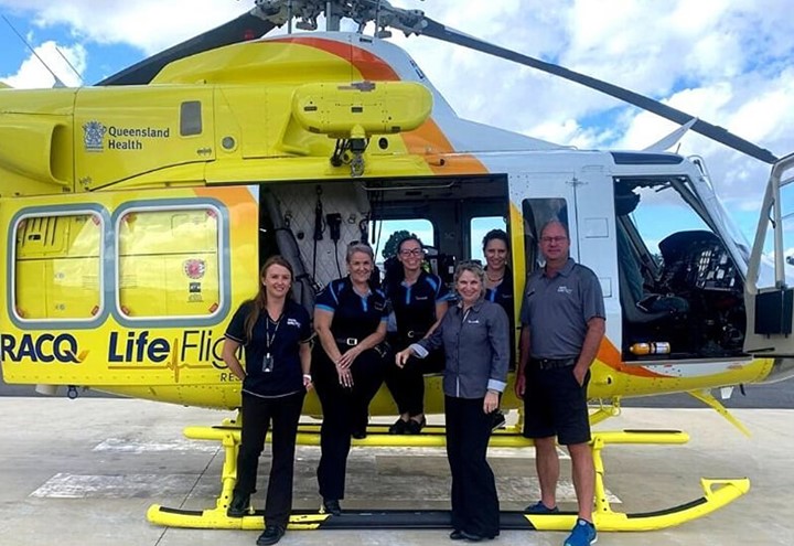 Team standing around the RACQ LifeFlight helicopter