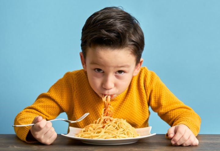 Boy eating spaghetti 