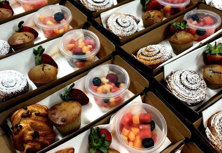 Catering boxes with fruit salad and muffin