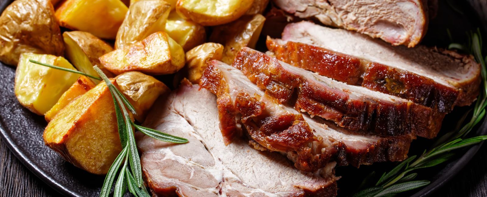 Cut roast meat on with roast potato and thyme