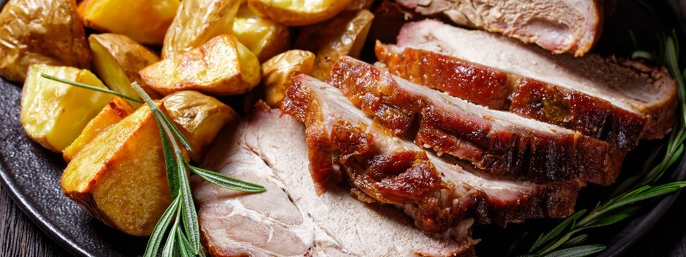 Cut roast meat on with roast potato and thyme