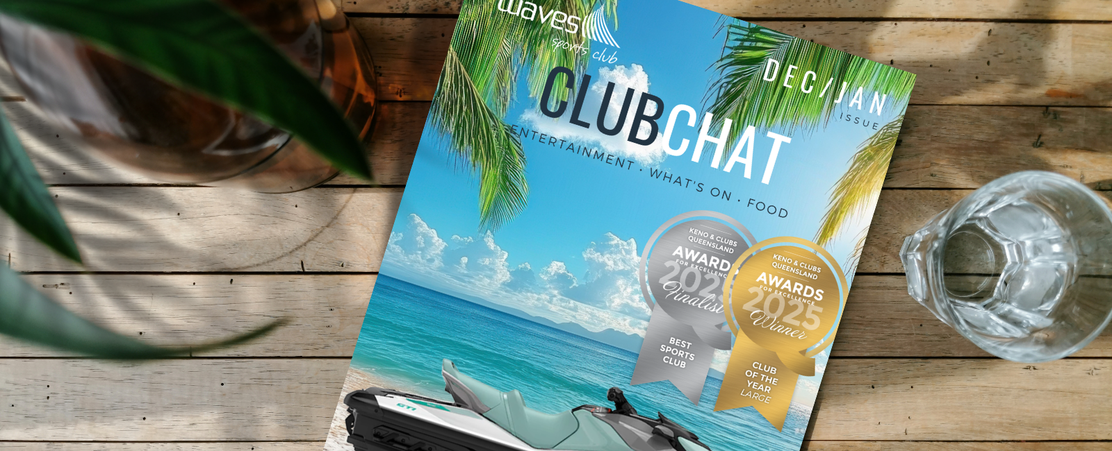 Hands holding tablet device with ClubChat magazine on screen