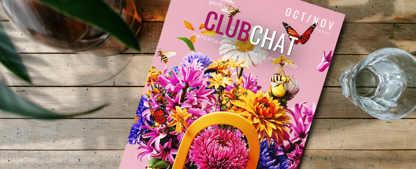 Hands holding tablet device with ClubChat magazine on screen